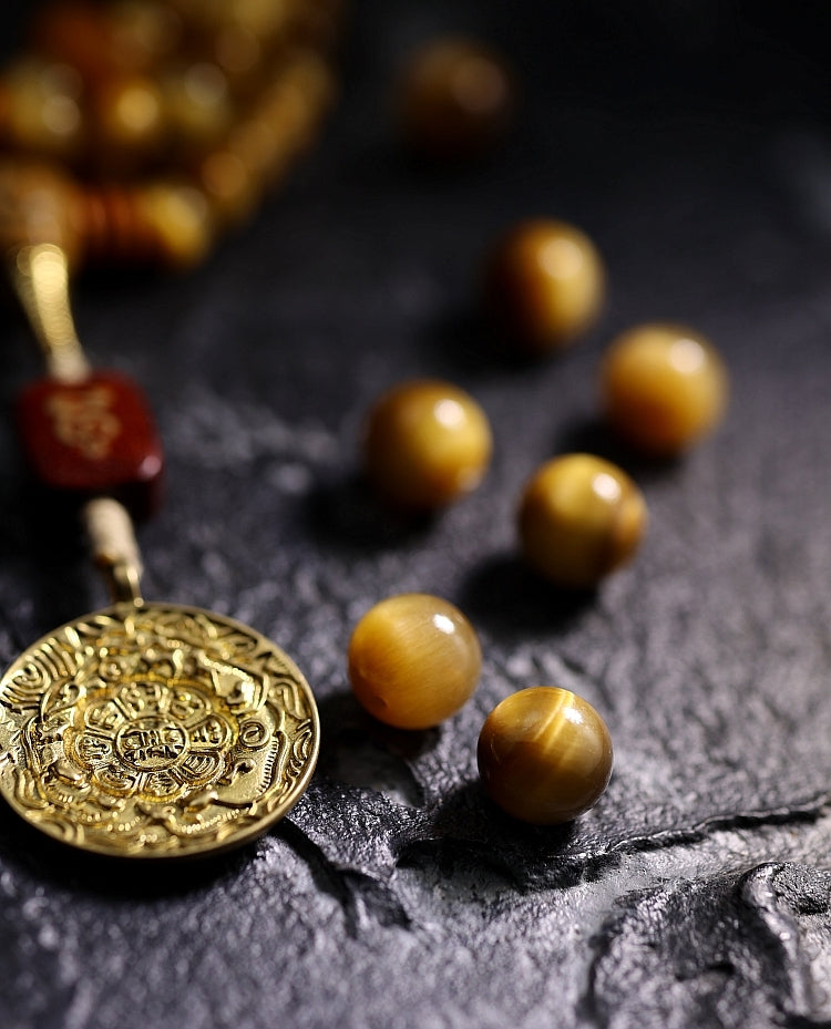Kailashforce Artisanal Tibetan Gold Tiger’s Eye 108 Bead Mala Bracelet Sandalwood Backcloud, Brass Nine Palaces Amber Tassel Sacred Jewelry for Men Women